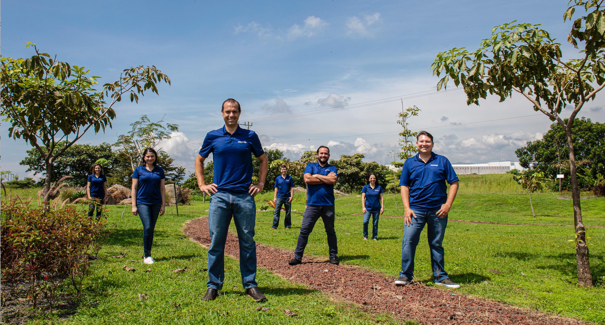 Hologic employees standing outdoors socially distanced FR 